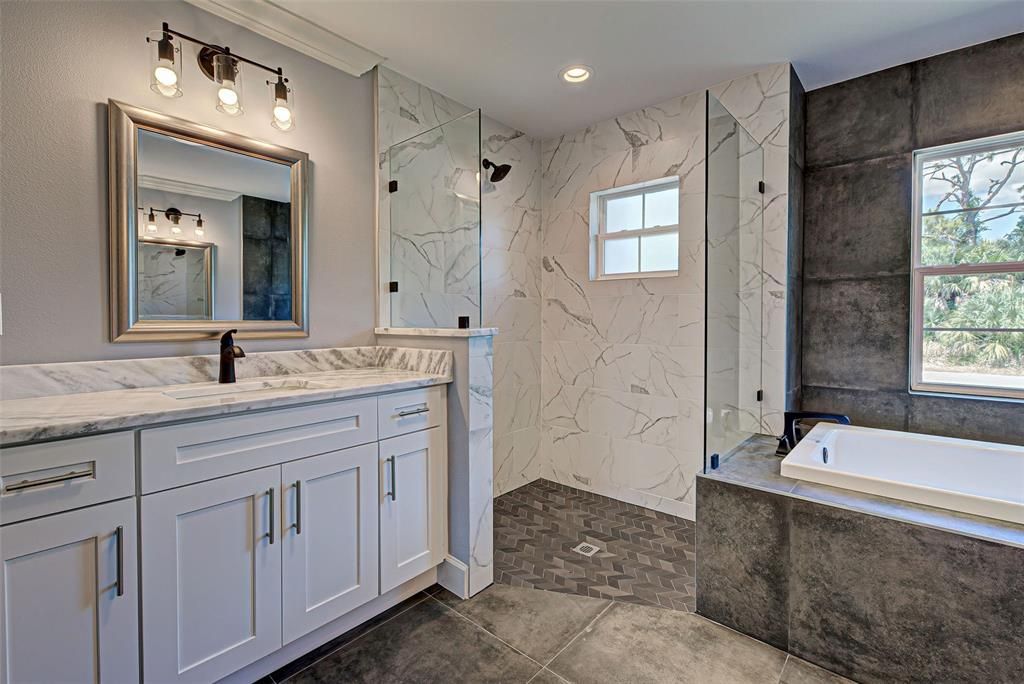Dual vanities with soft close drawers, storage galore, classy slate flooring and elegant lighting complete this beautiful bathroom.