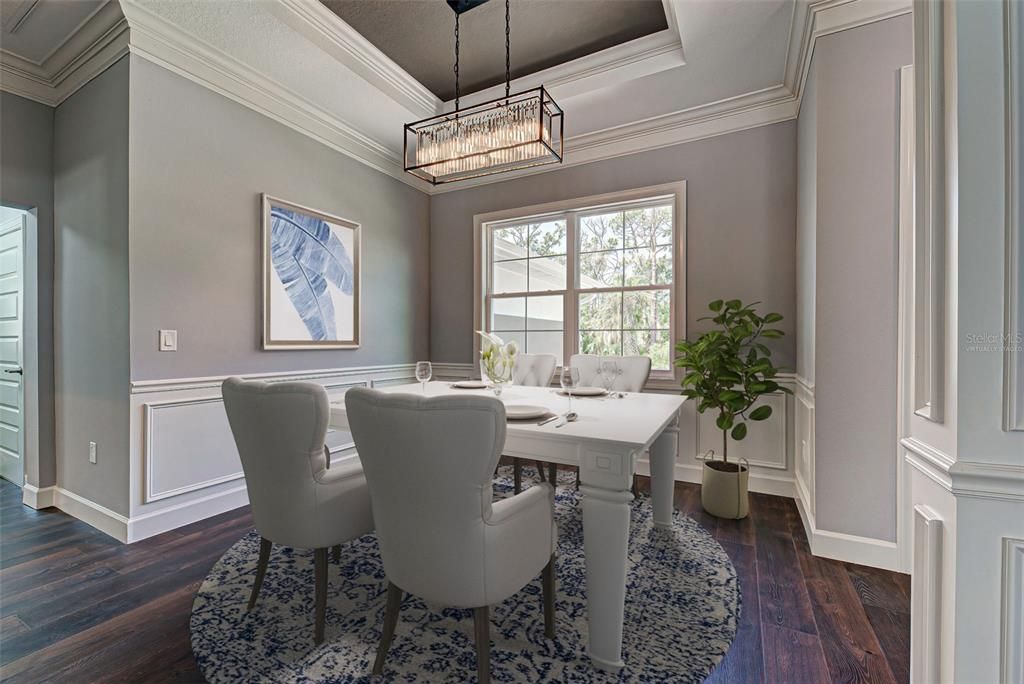 Virtually staged.  Enjoy a special meal in the formal dining room which offers detailed woodwork, natural lighting and a stunning chandelier.