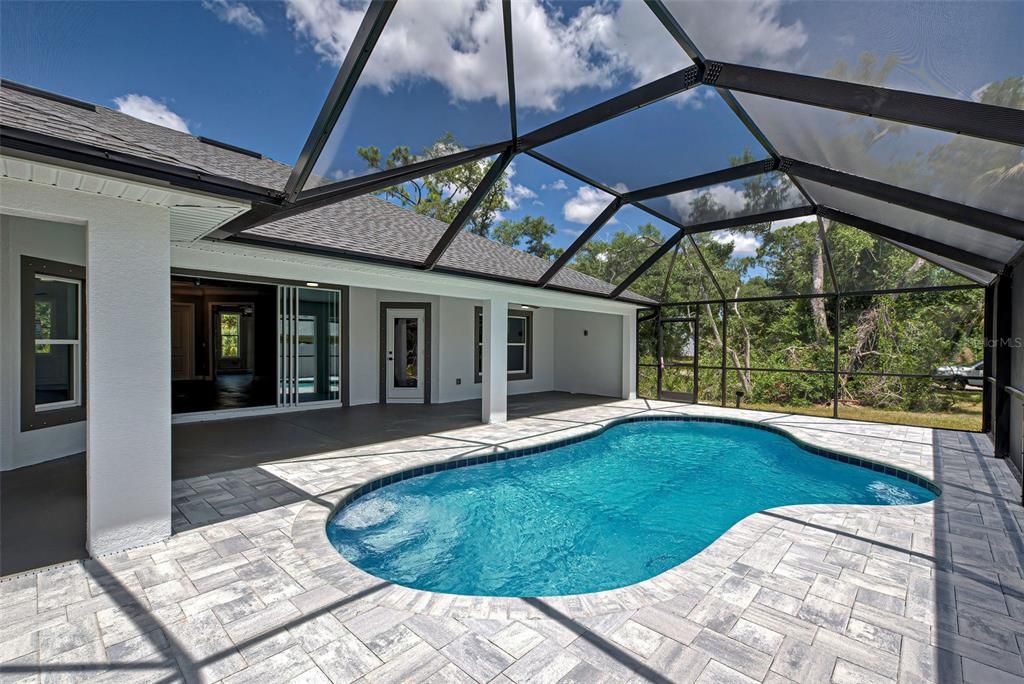 Lanai features lovely pavers and a brand-new pool cage.