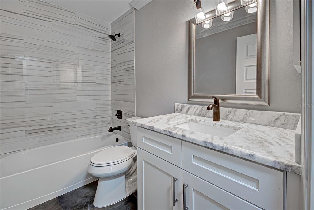 2nd full bathroom will spoil guests with its quartz countertops, beautiful shower and slate floors.