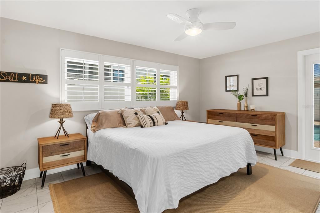 Master Bedroom with New Plantation Shutters, New Flooring, and Entry Directly onto your Pool Patio