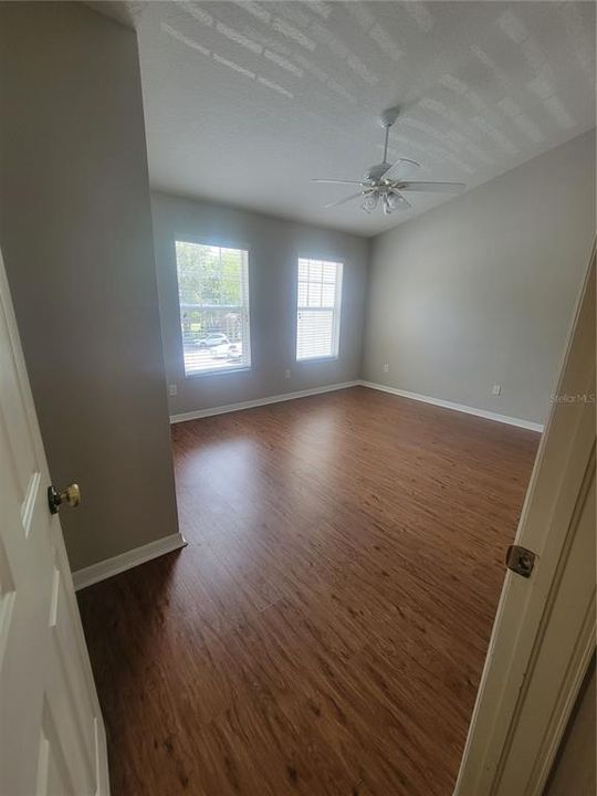 primary bedroom with hardwood floors and freshly painted walls, over sized walk in closet