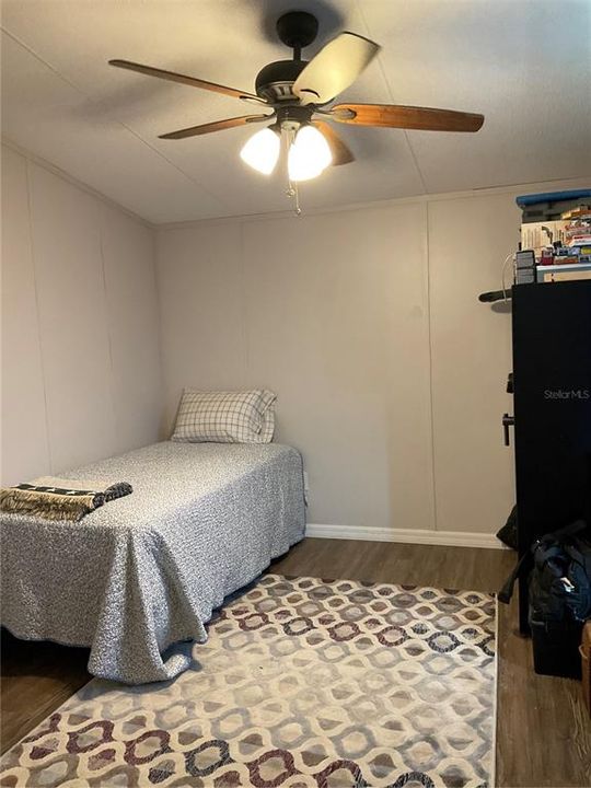 Bedroom three with walk in closet and ceiling fan