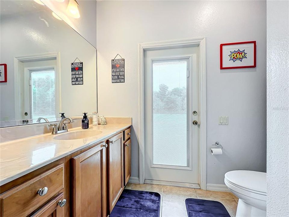 Guest bathroom with back yard access.