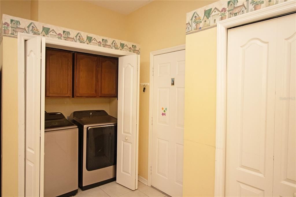 Kitchen with laundry, door to garage and