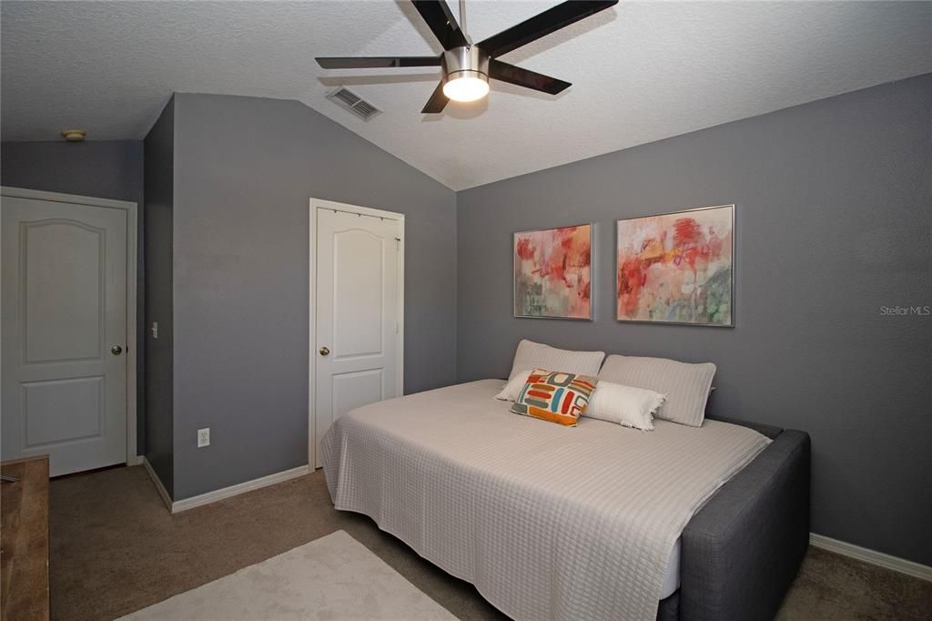 Primary Bathroom with dual sink vanity, walk-in shower, walk-in closet and private toilet