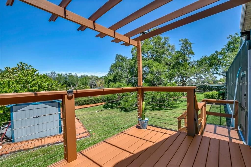 Deck with view of grand oak trees, canal and bayou