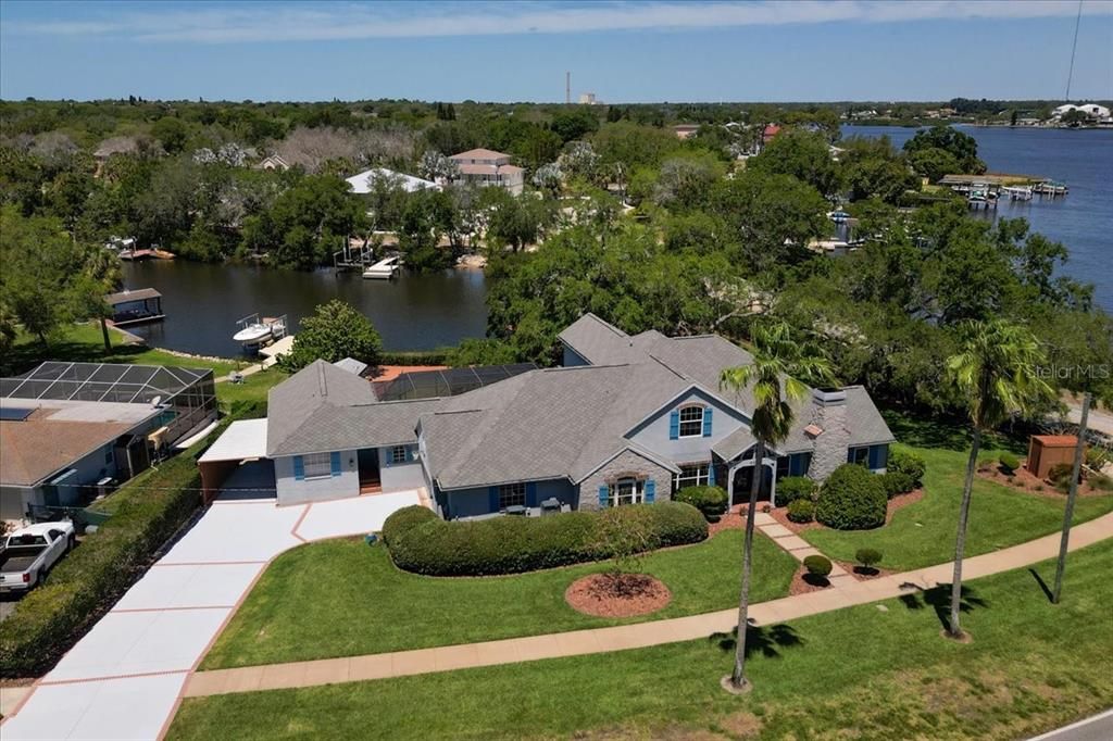 Front aerial view, large corner lot, canal water frontage and bayou views.