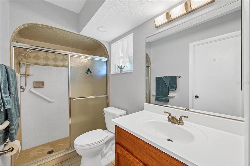 en suite with shower, updated vanity and toilet