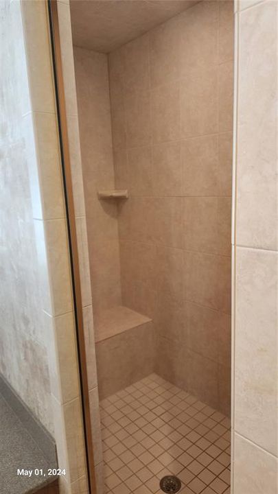 Owner's walk-in shower with tiled bench