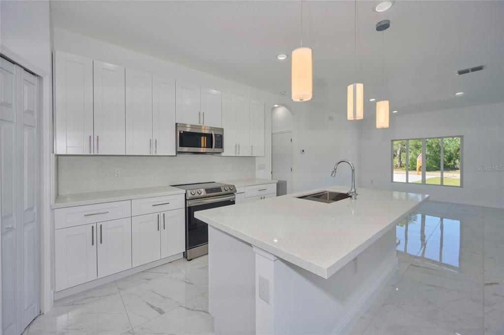 Kitchen has beautiful quartz counter tops and stainless steel appliances!