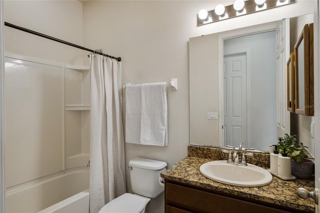 guest bathroom with granite counter tops.