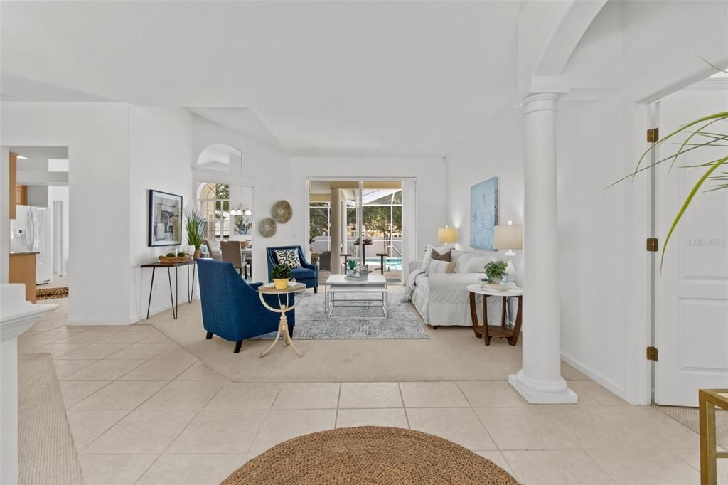 Welcome home to this cozy and inviting living room with views directly into the pool area.