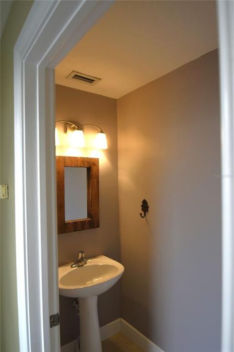 Half bath at entry door from attached tow car garage.