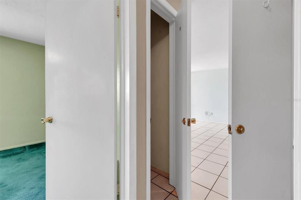 A little confusing but extra hall closet, carpet area is 2nd bedroom, and tiled area is front living room. It is also a closet on the right side, door is open. Two hall closets across from each other!
