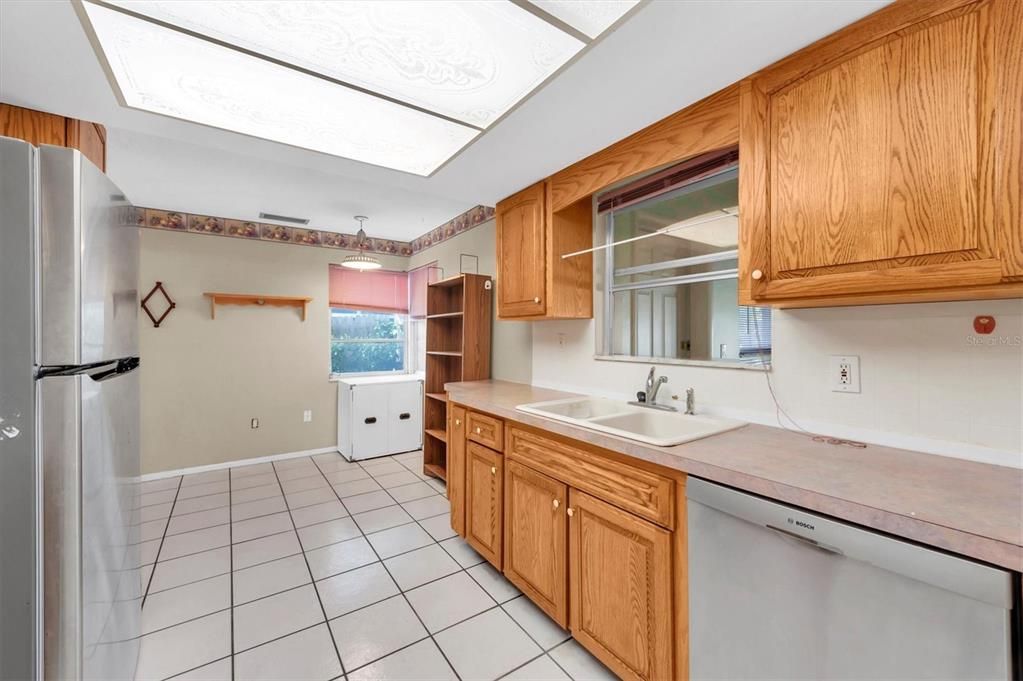 There's lots of space in this kitchen. Better view of bonus room pass through and space beyond the built in counters. Great for additional storage, or an office or craft/art area. What would you use it for?