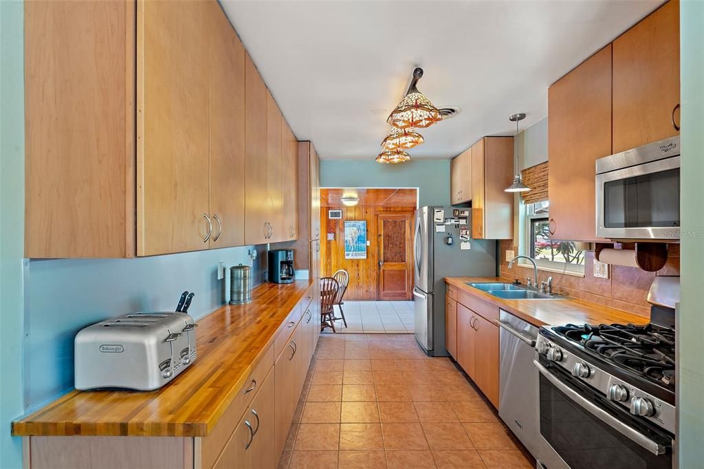 The thoughtfully renovated kitchen boasts honey-toned cabinetry.