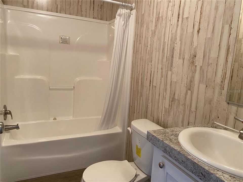 Second bath features tub shower combo