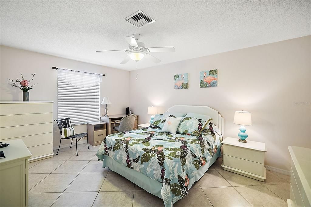 LARGE MASTER BEDROOM MEASURES 16X12 AND FEATURES A QUEEN BED, TILE FLOOR AND HUGE WALK IN CLOSET