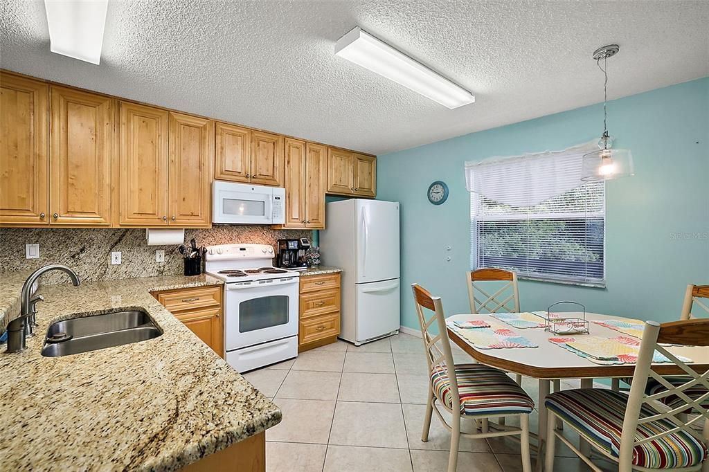 UPDATED KITCHEN FEATURES GRANITE COUNTERS, BEAUTIFUL  42 " WOOD CABINETS, WITH SPACE FOR EAT-IN KITCHEN