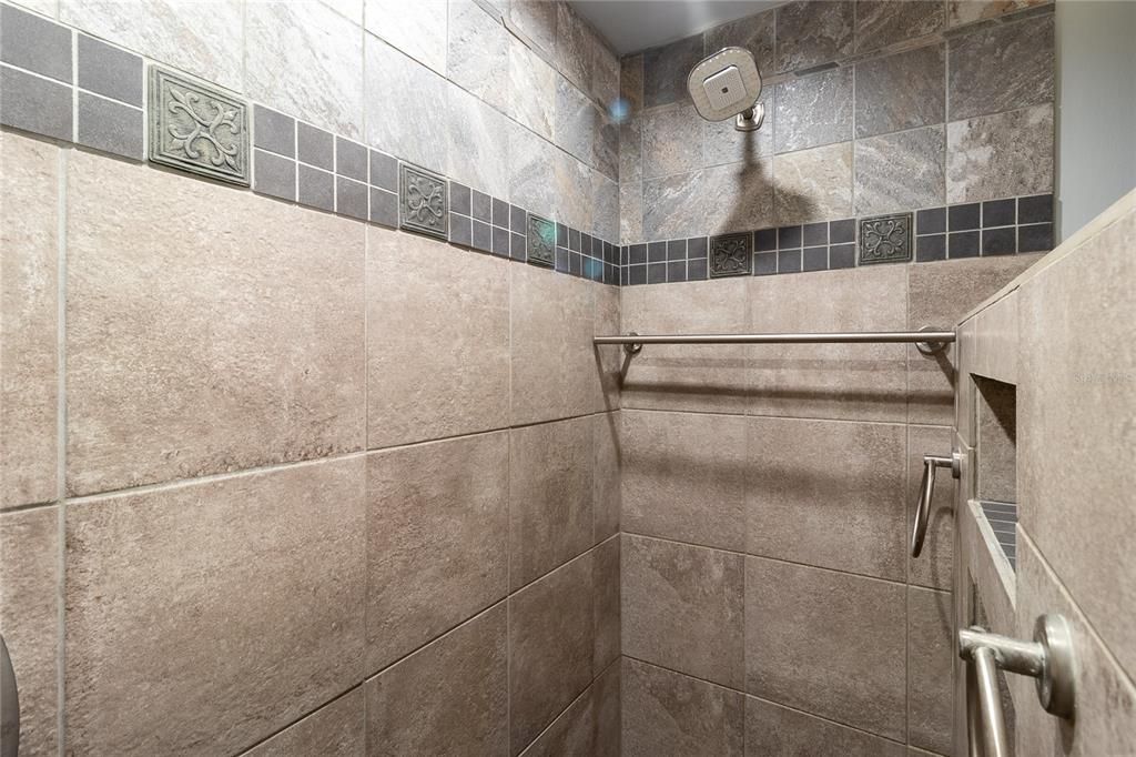 Tiled primary bathroom shower.