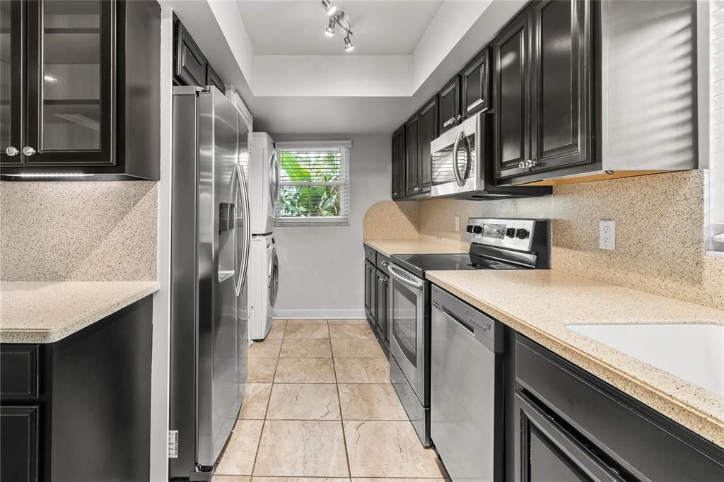 Kitchen with Stainless Steel Samsung appliances, LG stackable washer and dryer.  Corian counters with corian backsplash.  Comes with 2 corian cutting boards.
