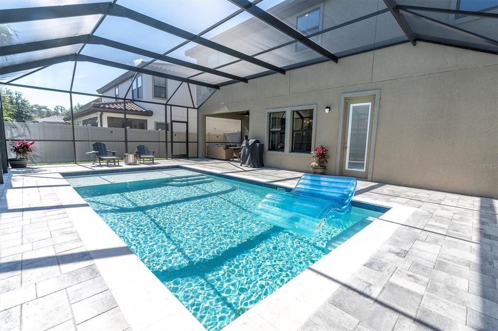 SCREENED POOL WITH PLENTY OF PAVER SPACE