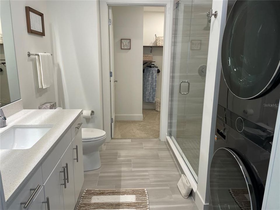 En-suite Bathroom with washer dryer and shower