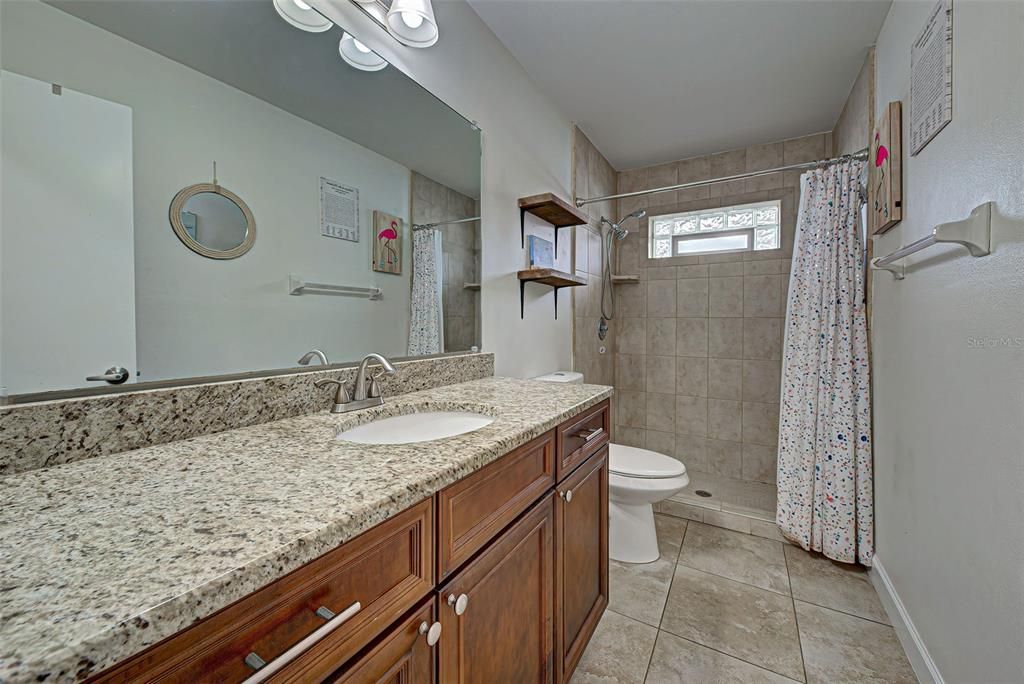 2nd full bathroom, also with granite countertops and tiled walk-in shower.