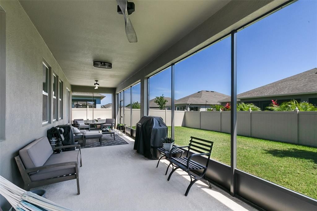Outside, relax on your screened lanai overlooking the fenced backyard, providing a private oasis for outdoor enjoyment.