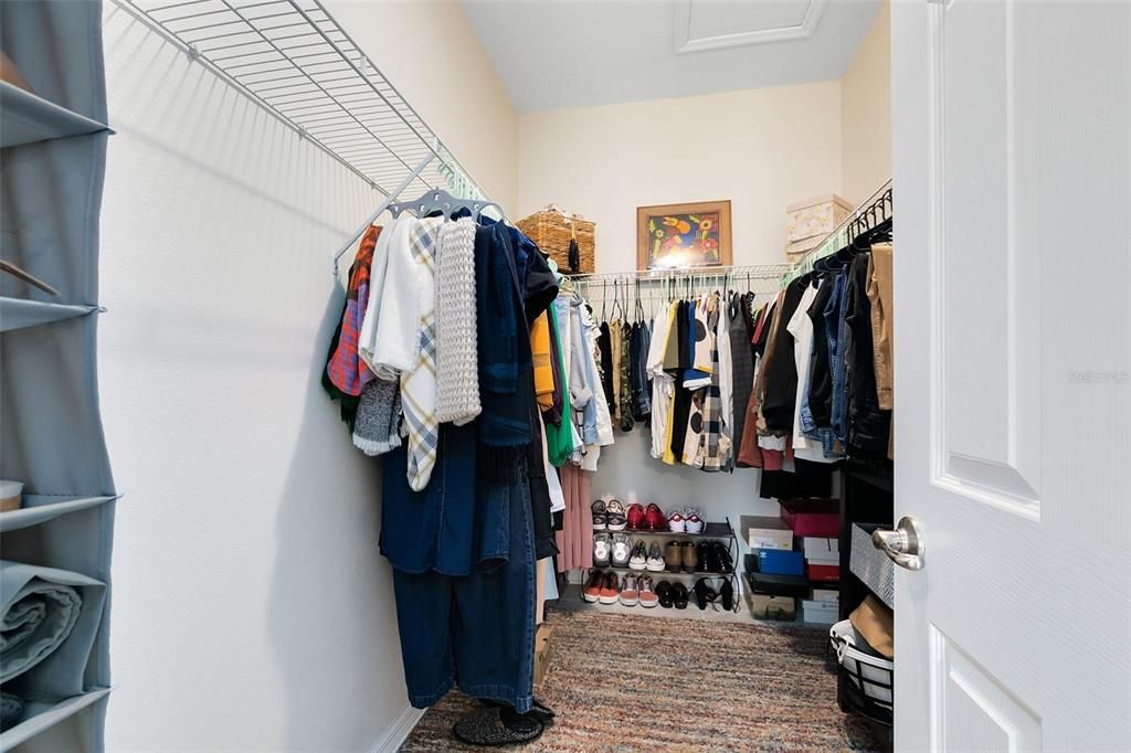 A large walk-in closet provides ample space for clothes, shoes and accessories.