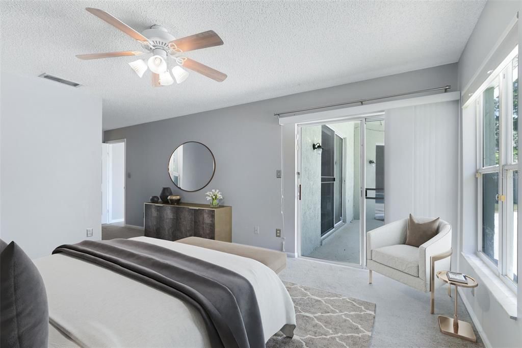 This photo has been virtually staged. The master bedroom features private pool acess via sliding glass doors.