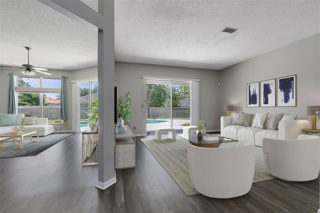 This photo has been virtually staged. Upon entering, you'll be greeted by a spacious living room and dining room combination, adorned with sliding glass doors that flood the space with natural light and offer seamless access to the pool deck and backyard.