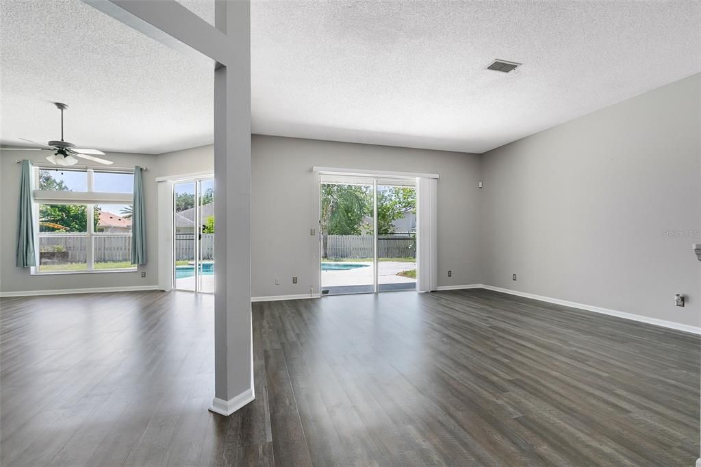 Upon entering, you'll be greeted by a spacious living room and dining room combination, adorned with sliding glass doors that flood the space with natural light and offer seamless access to the pool deck and backyard.