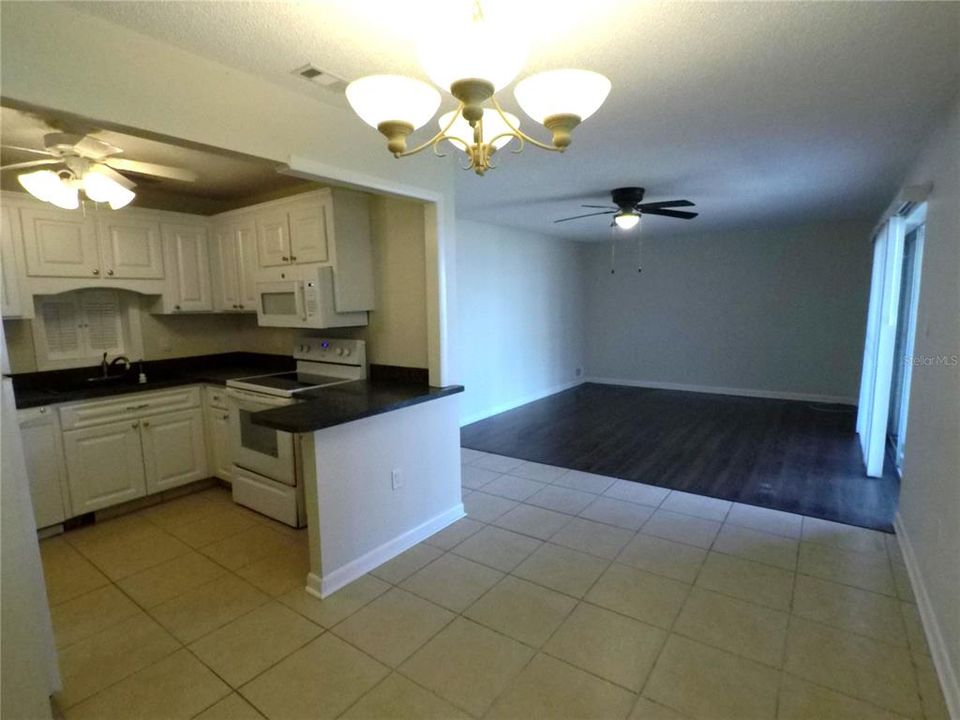 Kitchen & Dining Area across to Living Room and sliders to covered lanai