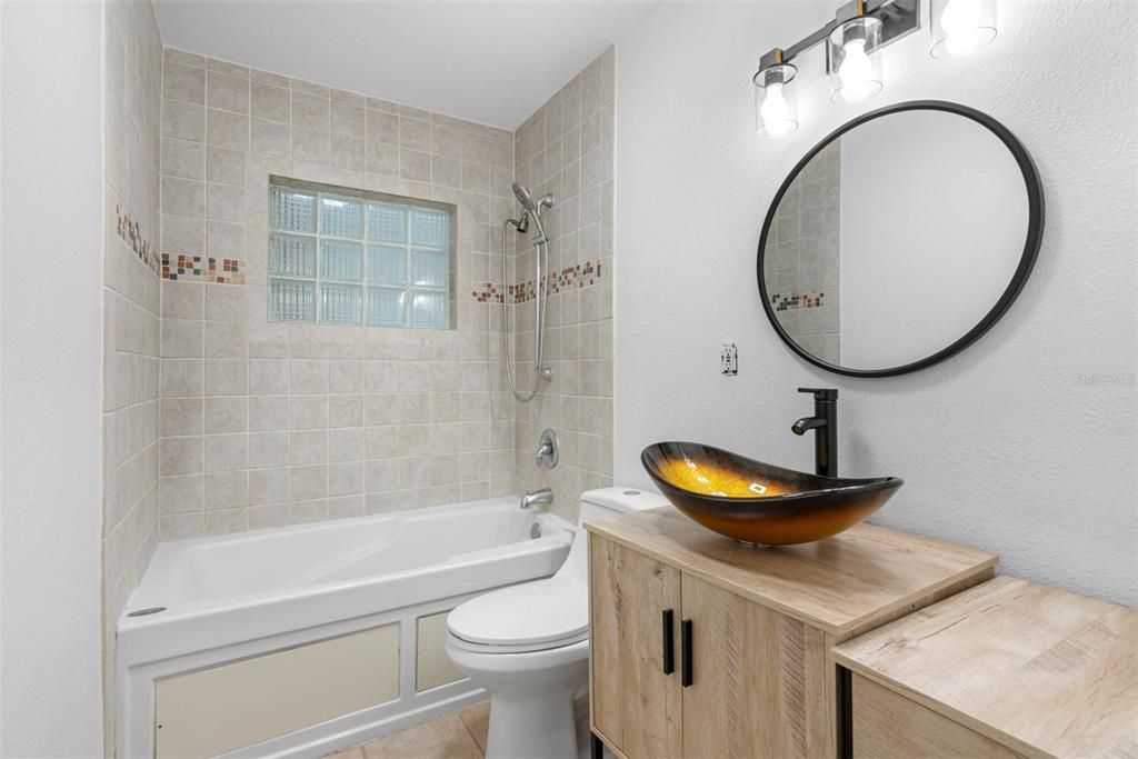 Hall bathroom with jacuzzi tub/shower combo