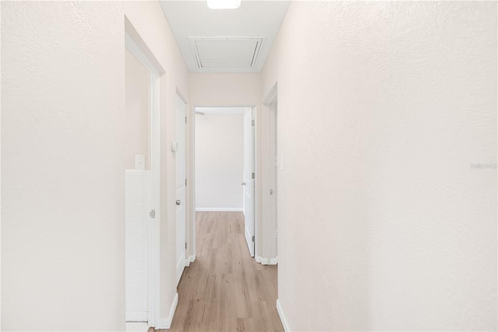 Hallways leading to bedrooms and bathroom