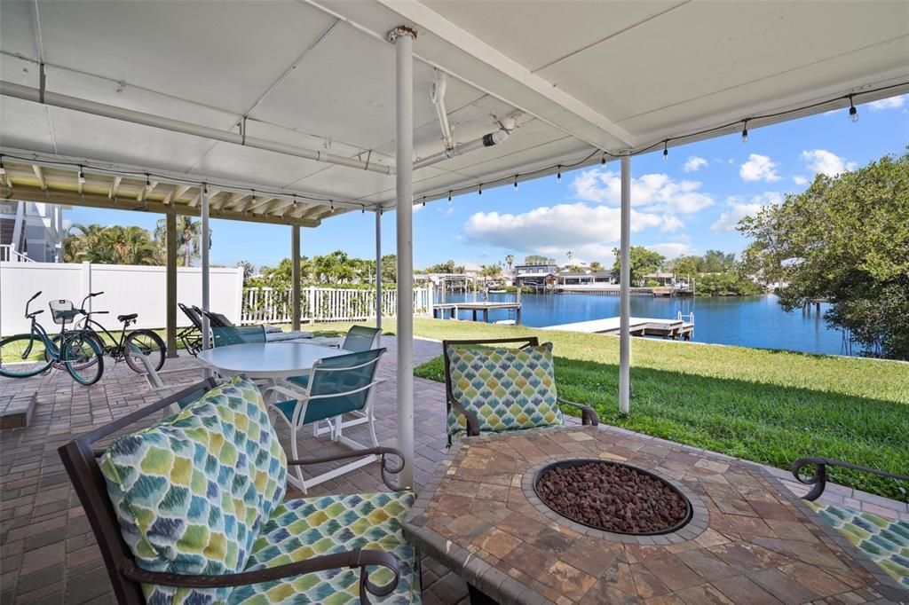 Covered Patio area with firepit, grills , waterfront views