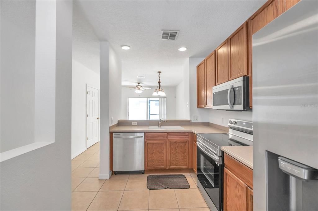 Kitchen with stainless steel appliances, including a brand new fridge