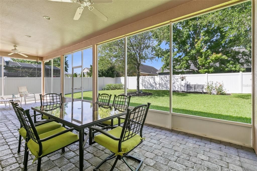 Large sliders invite you to your private fenced backyard featuring an enormous screened back patio!