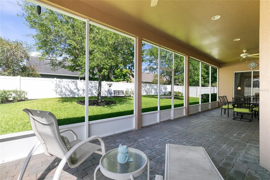 Large sliders invite you to your private fenced backyard featuring an enormous screened back patio!
