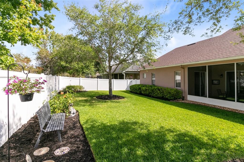 Private fenced backyard featuring an enormous screened back patio!