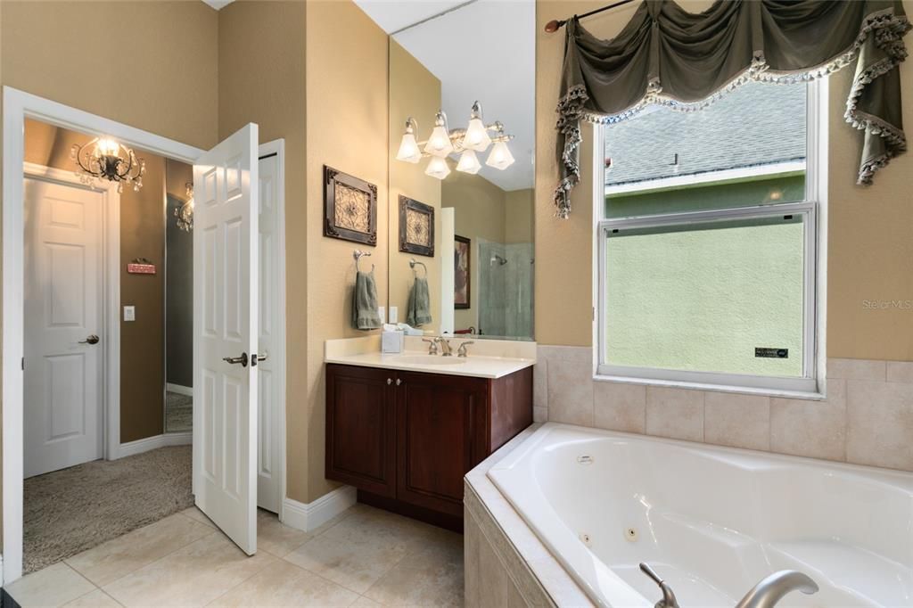 Into the master bedroom complete with tray ceiling, crown molding & an en-suite bathroom, featuring 2 huge walk in closets, separate sinks, jacuzzi tub & updated seamless separate shower.
