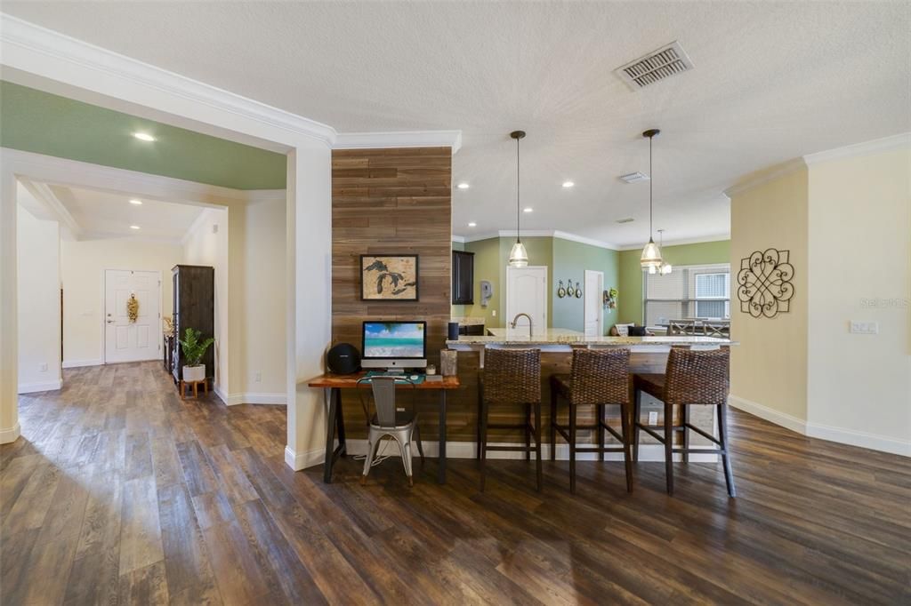 The natural flow takes you into the home chef’s dream kitchen, open to a casual dining space and generous family room with endless cabinet and pantry storage, GRANITE COUNTERTOPS, a large center island, STAINLESS STEEL APPLIANCES and breakfast bar seating under pendant lighting.