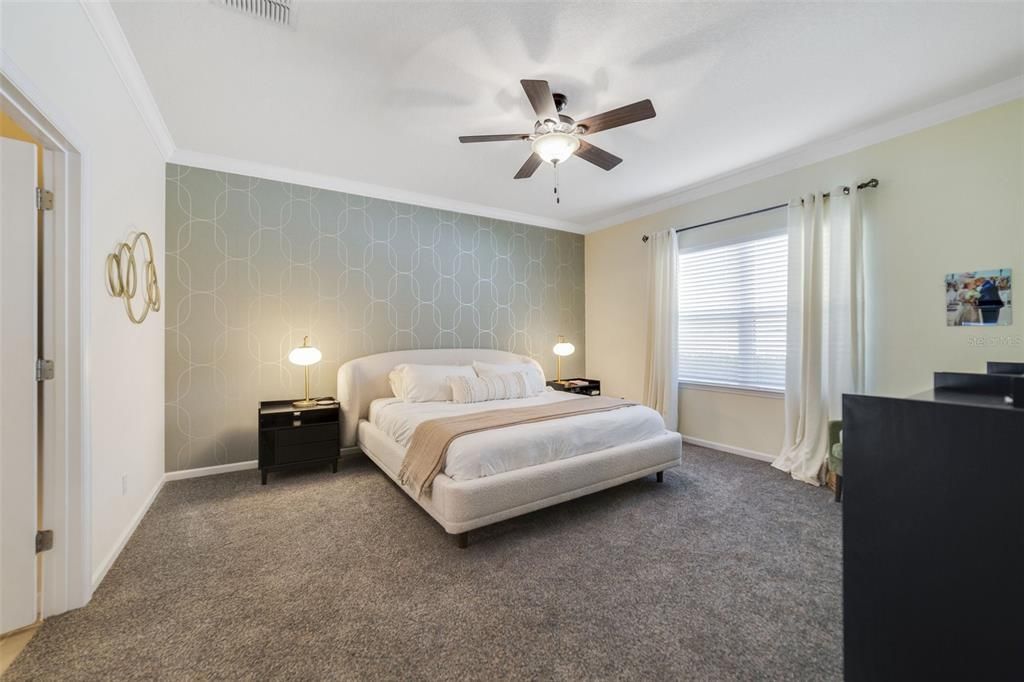 Ideal SPLIT BEDROOMS delivers a must see PRIMARY SUITE with a stylish accent wall, NEWER CARPET (2020), WALK-IN CLOSET and private bath.