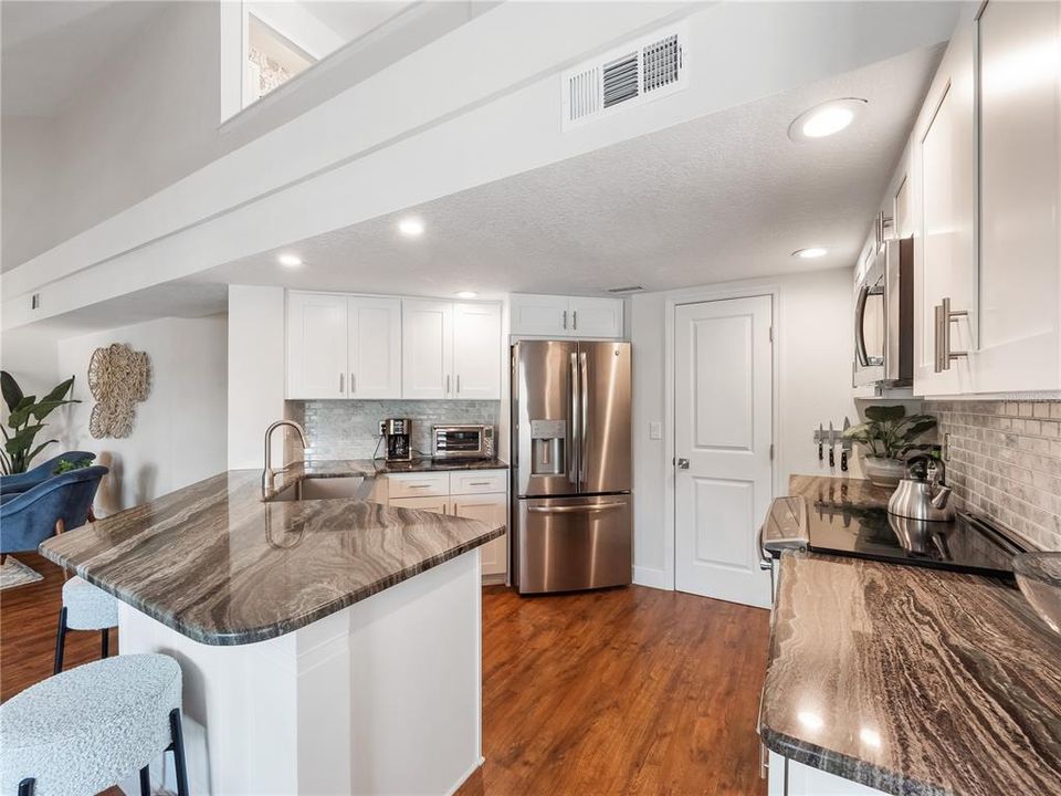Gleaming stone countertops and updated stainless steel appliances will impress your guests.