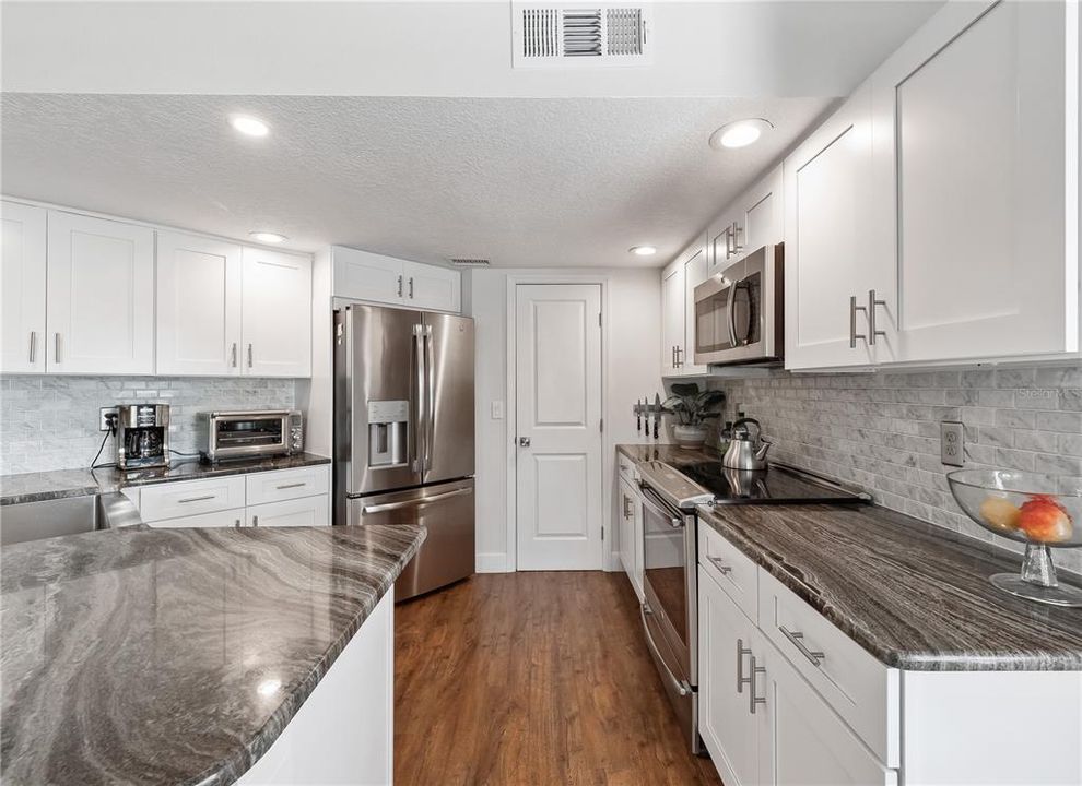 Gleaming stone countertops and updated stainless steel appliances will impress your guests.