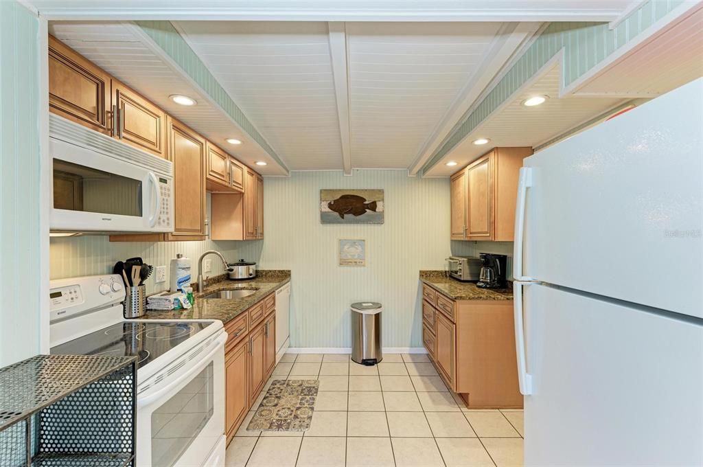 Kitchen in unit Two has granite counter tops and updated cabinets.