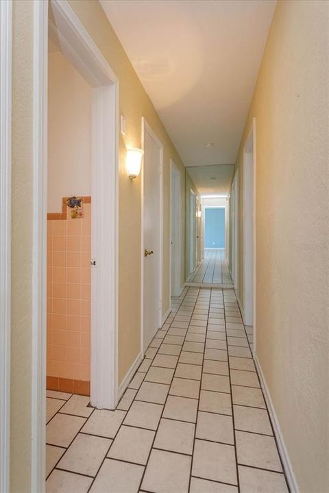 Hallway to bedrooms includes a large storage closet
