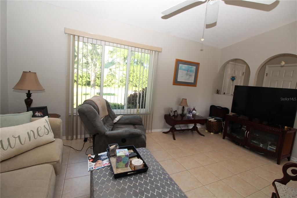 Living room with nice size hurricane impact window looking out to your luxurious landscaped yard....